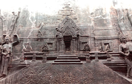 Angkor Wat, Cambodia - January 20, 2020: Churning Sea of Milk bas relief at Angkor Wat temple. The Angkor Wat is a Hindu temple complex in Cambodia and is the largest religious monument in the world.
