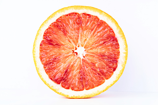 Single blood orange slice on white background.