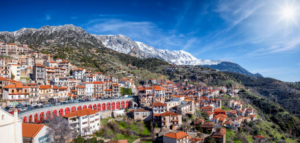Panorama of the mountain town Arachova, Greece Panorama of the town Arachova, Greece, next to Parnassus mountain during a sunny winter day with snow capped mountains and sunshine arachova greece stock pictures, royalty-free photos & images