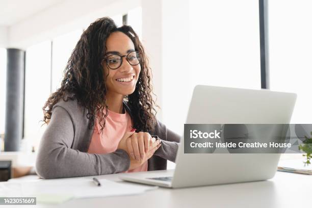 Happy Young African Student Businesswoman Freelancer Watching Video Webinars Online Having Videocall Conversation Elearning Tutoring At Home Office Stock Photo - Download Image Now