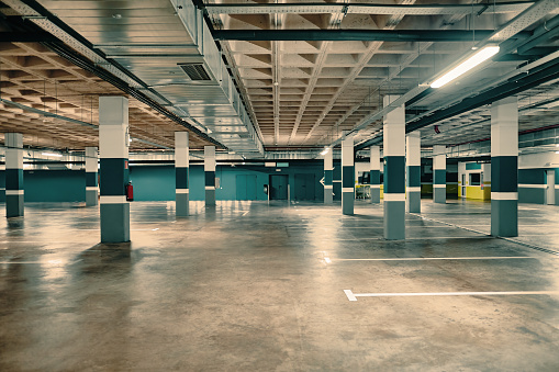 Empty underground parking in modern building.