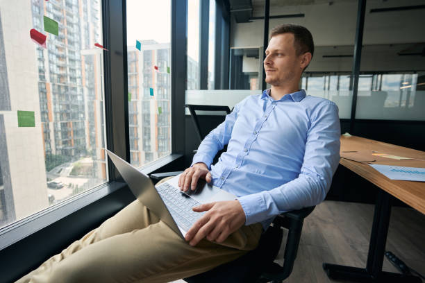 istock Young office worker daydreaming in his workplace 1423054606