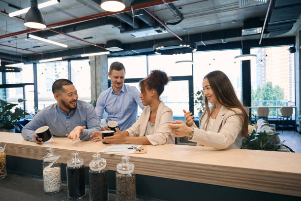 istock Cheerful corporate employees communicating at coffee break 1423054688