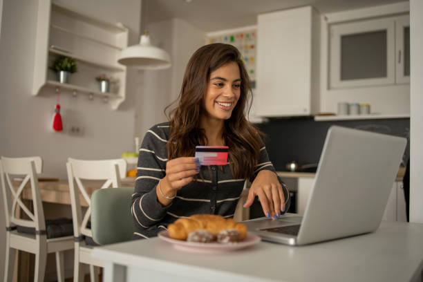 istock Cheerful  woman doing online shopping 1423056554