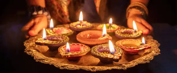 Photo of Diwali. Diya oil lamps lit at Deepavali celebration. Hindu Festival of lights India.