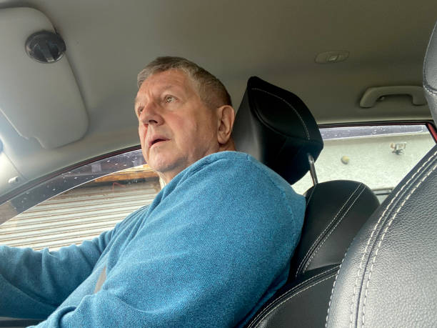 istock Senior man driving in car 1423061552