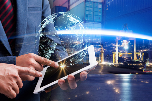 Businessman using digital tablet. Business global internet connection application technology digital marketing, Financial and banking with sea port background. Elements of this image furnished by NASA