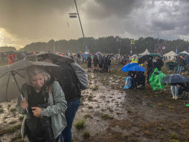 Leopoldsburg, Belgium, - September 10, 2022. People watching an airshow in the middle of a rain shower.