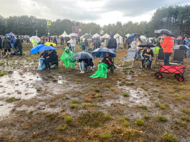 Leopoldsburg, Belgium, - September 10, 2022. People watching airplanes at the International Sanicole airshow in the middle of a rain shower.