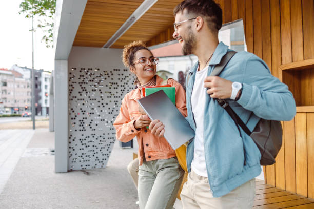 istock Students talking and waiting a bus on a station 1423064187