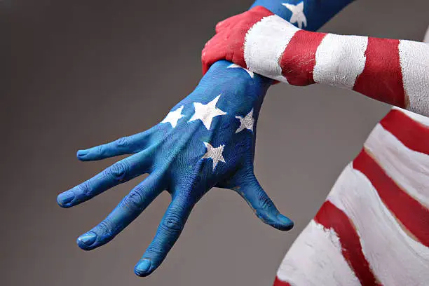 Hands of a woman painted in the USA flag colors