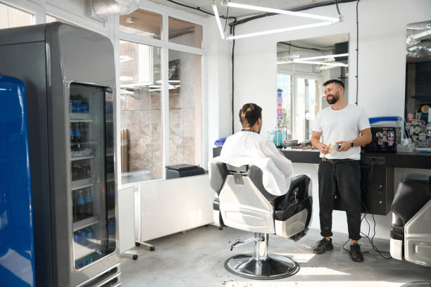istock Pleasant hair salon worker entertaining his guest with conversation 1423070870