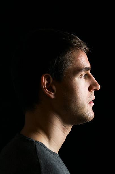 istock profile of young man on black 142307209