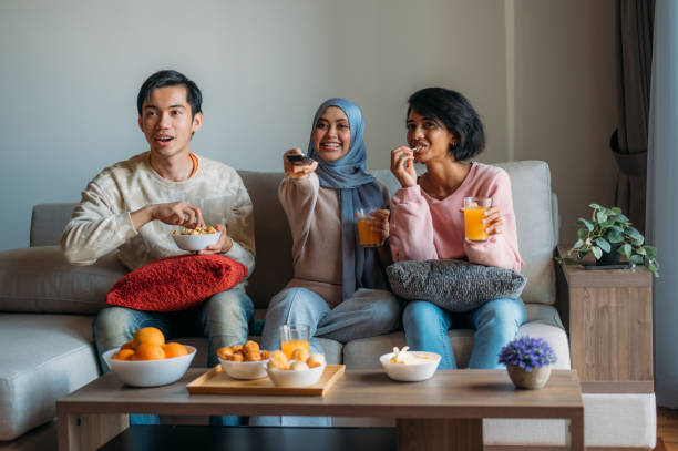 Friends together watching tv at home