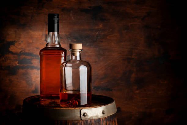 istock Bottles of whiskey on the old barrel 1423080273