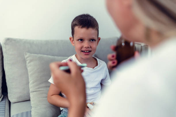 istock Little boy taking a spoon of medicine. 1423080290