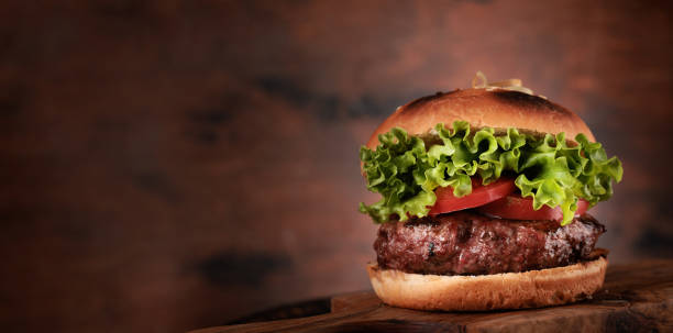 istock Homemade hamburger with large beef cutlet and fresh vegetables 1423080606
