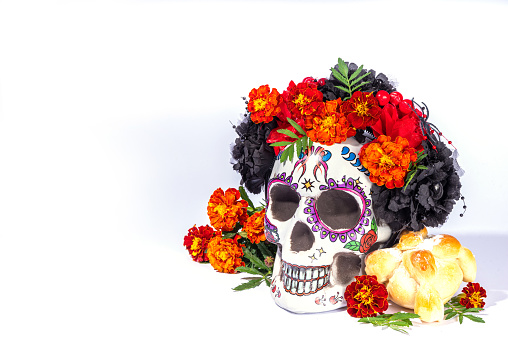 Spanish Mexican traditional holiday, autumn festival Day of the Dead (dia de los muertos) background. With traditional Pan de Muerto bread, decorations and Marigold and cempasuchil  flowers