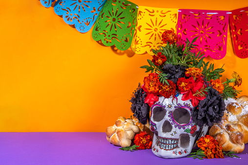 Spanish Mexican traditional holiday, autumn festival Day of the Dead (dia de los muertos) background. With traditional Pan de Muerto bread, decorations and Marigold and cempasuchil  flowers