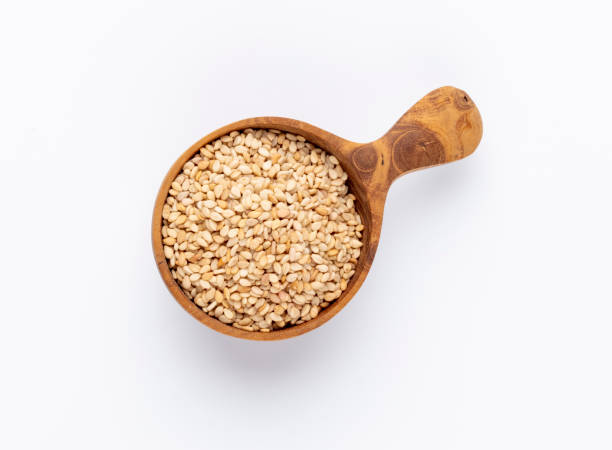 istock Bio natural sesame seeds on wooden bowl. 1423089979