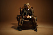 Serious retro 1920s style english gangster headed of dog head wearing suit and cap isolated over dark vintage background. Concept of business, art, surrealism