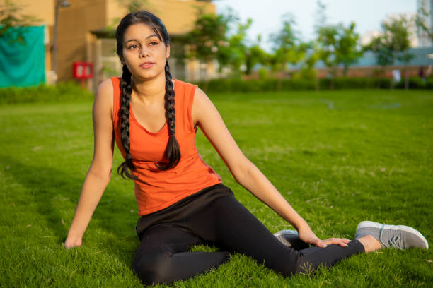 Woman doing yoga asana and exercise at the park in the morning. Woman doing yoga asana and exercise at the park in the morning. black hair braiding stock pictures, royalty-free photos & images