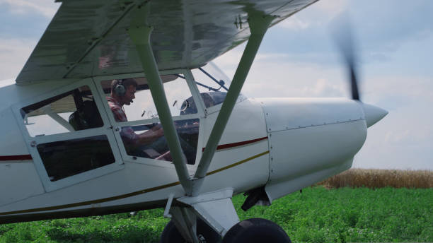 istock Airplane pilot turning off engine after landing on field. Man parking aircraft. 1423108899