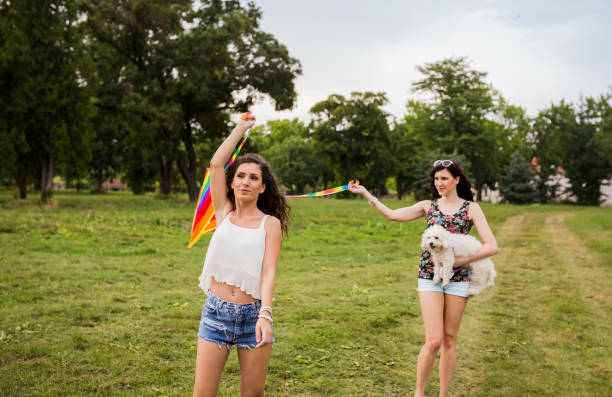 istock Women running with a kite on a meadow at sunset 1423111015