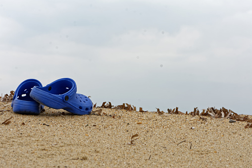 Beach slippers on sand
