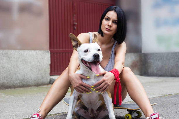 istock Young woman hugging her dog and laughing 1423111325