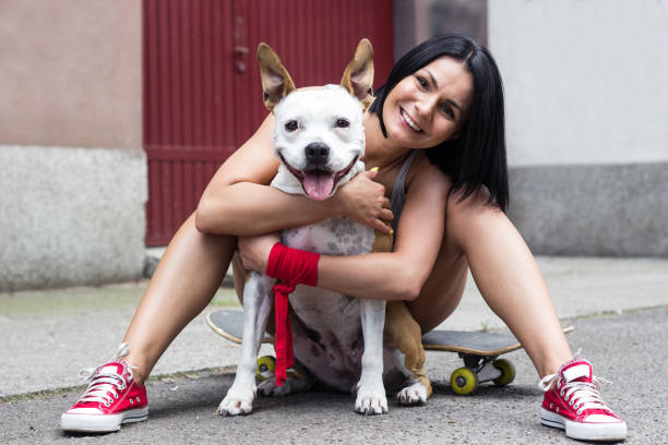 istock Young woman hugging her dog and laughing 1423111364