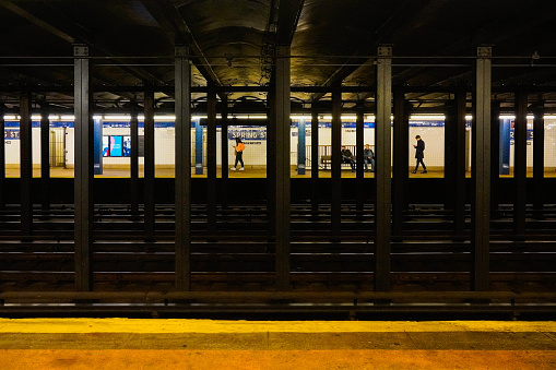 Subway platform Spring Street in New York with few people. New York, USA, December 2021