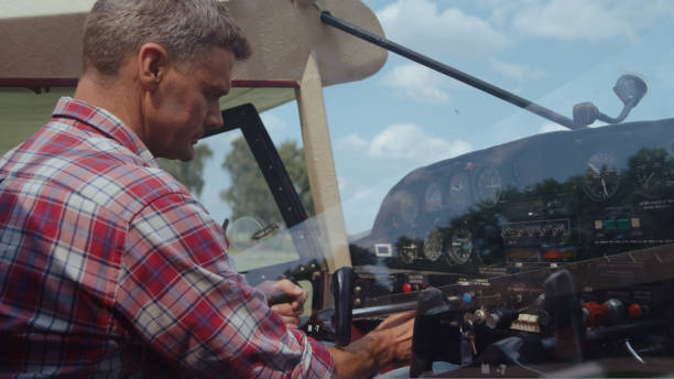 istock Aviation engineer sitting cabin airplane making preflight procedure close up. 1423113517