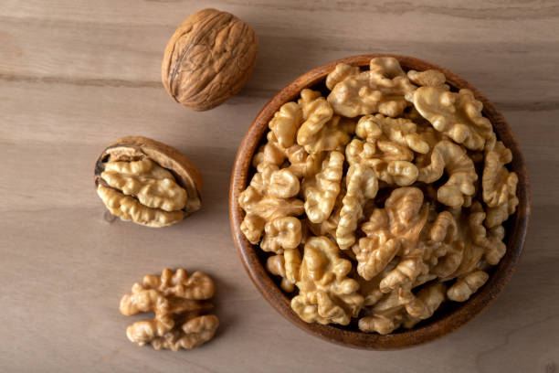 istock Group of peeled walnuts and whole walnuts,directly above 1423114878