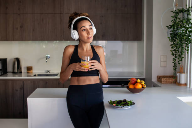istock Content woman drinking juice in morning 1423115430