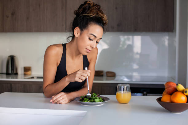 istock Woman eating salad in morning 1423115584