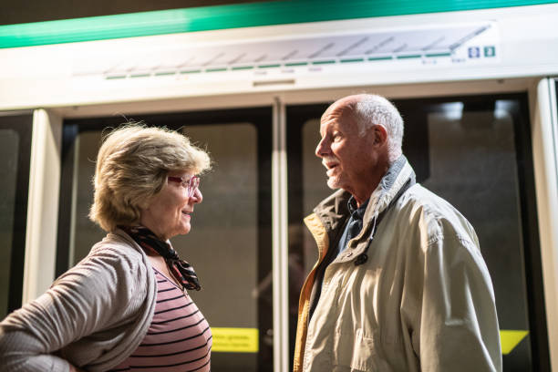 istock Senior couple talking on the subway platform 1423116798