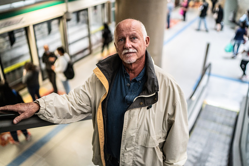 Senior man on the escalator in the subway station