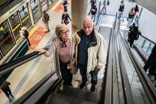 Senior couple on the escalator in the subway station