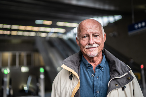 Portrait of a senior man in a subway station