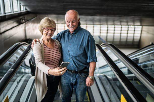 istock Senior couple on a video call using mobile phone in a subway station 1423119670