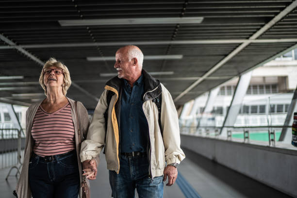 istock Senior couple walking in a subway station 1423119965