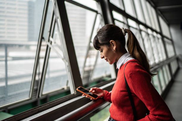 istock Young woman using the mobile phone in a subway station 1423121254