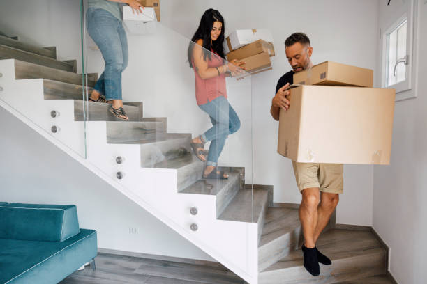 istock Group of students carrying cardboard boxes for relocation 1423121930