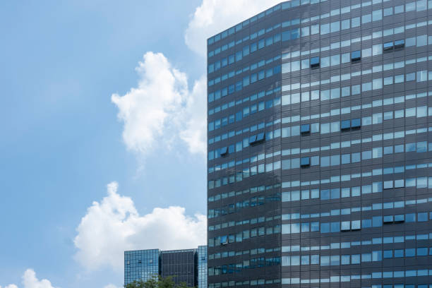 istock Facade of modern building under blue sky and white clouds 1423121932