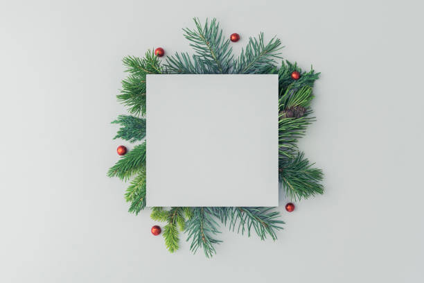 istock Christmas layout of a square note and spruce branches on a white background. 1423122418