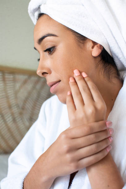 istock Lovely woman applying makeup in morning 1423124294