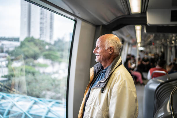 istock Senior man looking through window in the subway train 1423124303