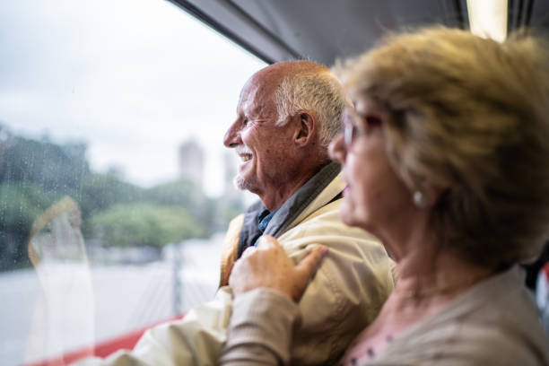 istock Senior couple looking through window in the subway train 1423124372