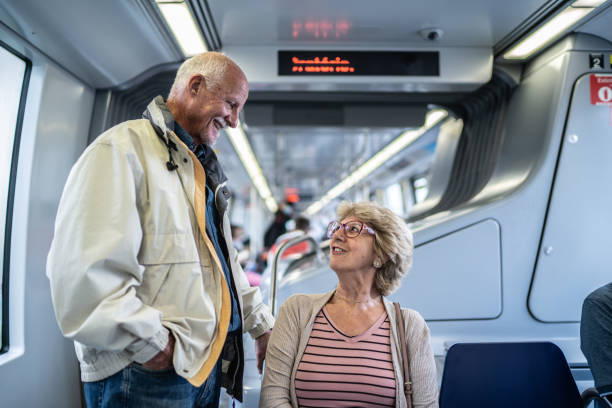 Senior couple talking in the subway train